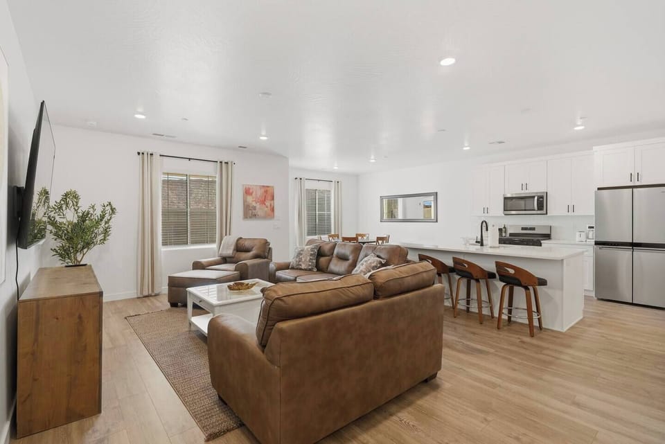 Open living area with comfortable seating and full kitchen.