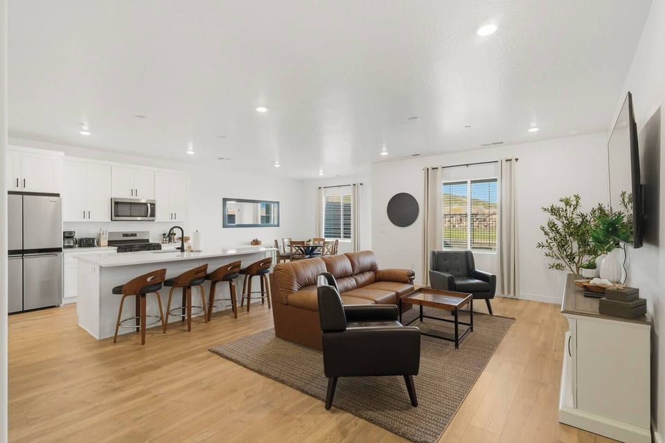 Modern open living space combining kitchen, dining, and cozy seating area.