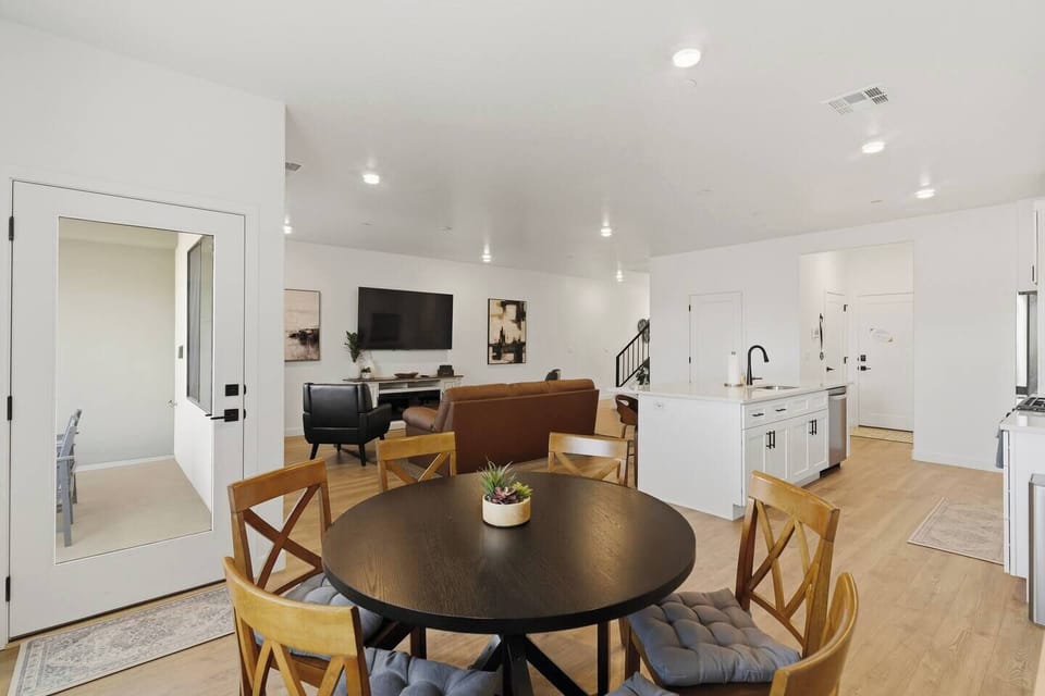 Modern open kitchen with large island, bar seating, and stainless steel appliances.