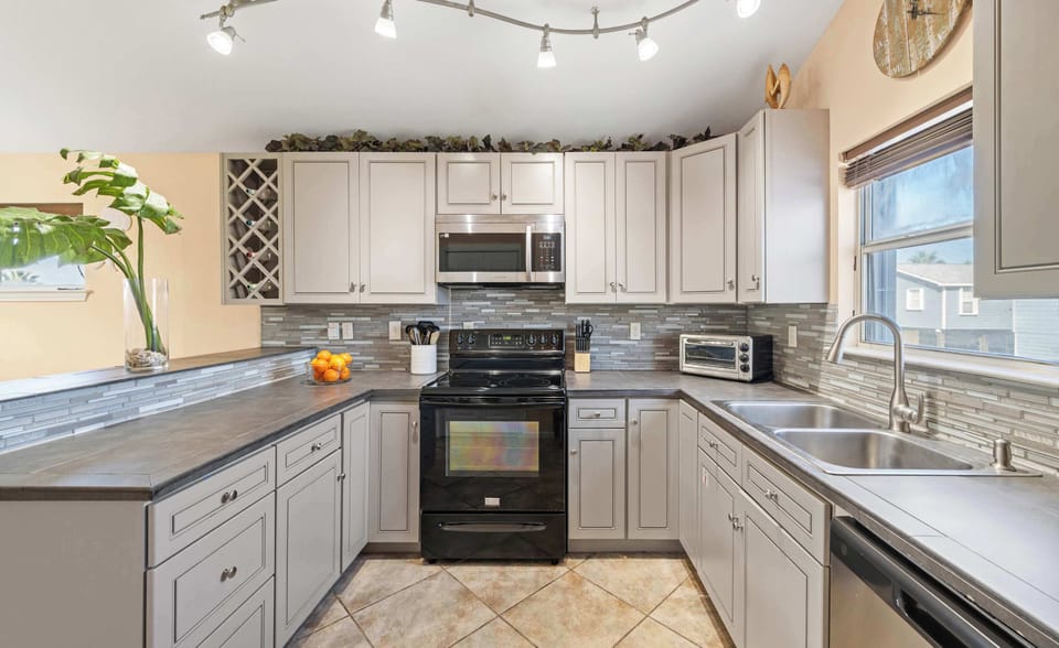 Kitchen — Stainless Appliances, Track Lighting & Wine Rack