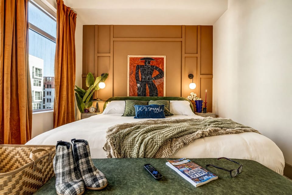 Cozy designer bedroom with king bed, city light, and warm modern style