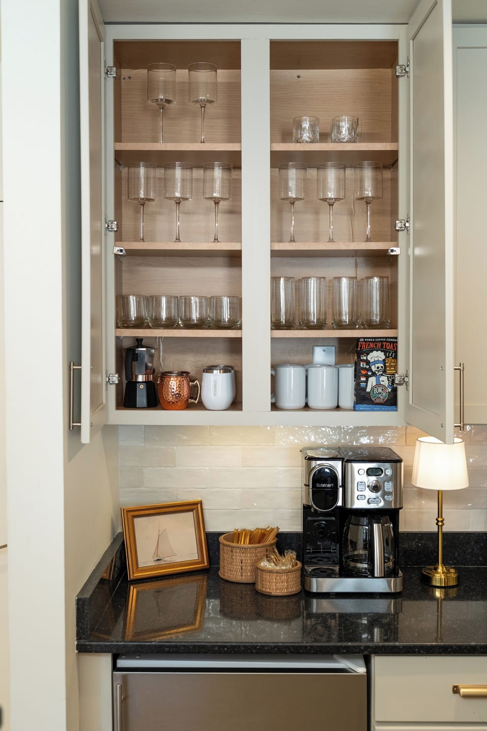 Fully stocked coffee station with glassware, mugs, and everything you need to start your day