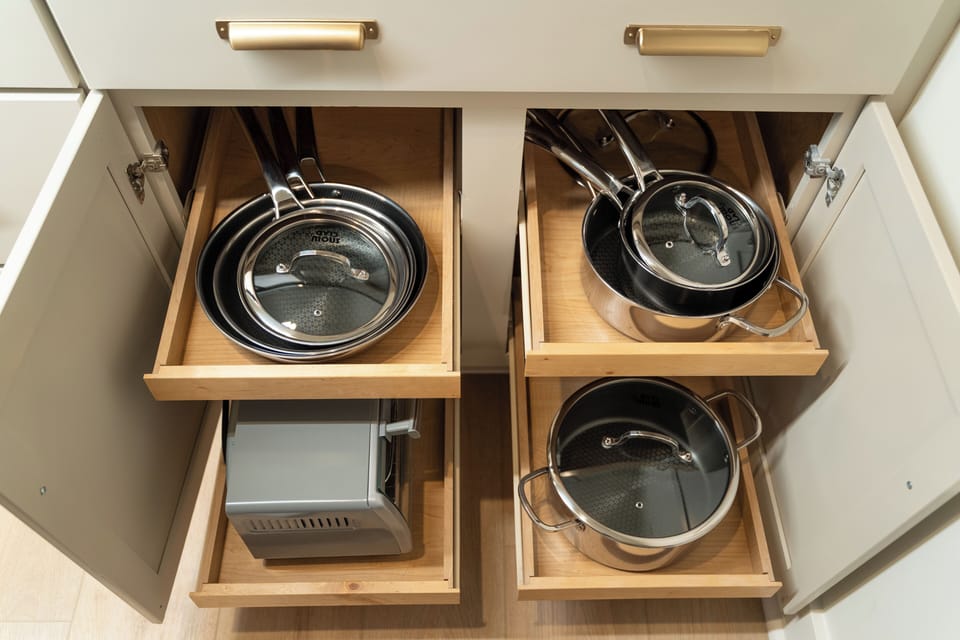 Fully stocked clad style cookware and pots, and a toaster/air fryer combo - everything you need for cooking at home