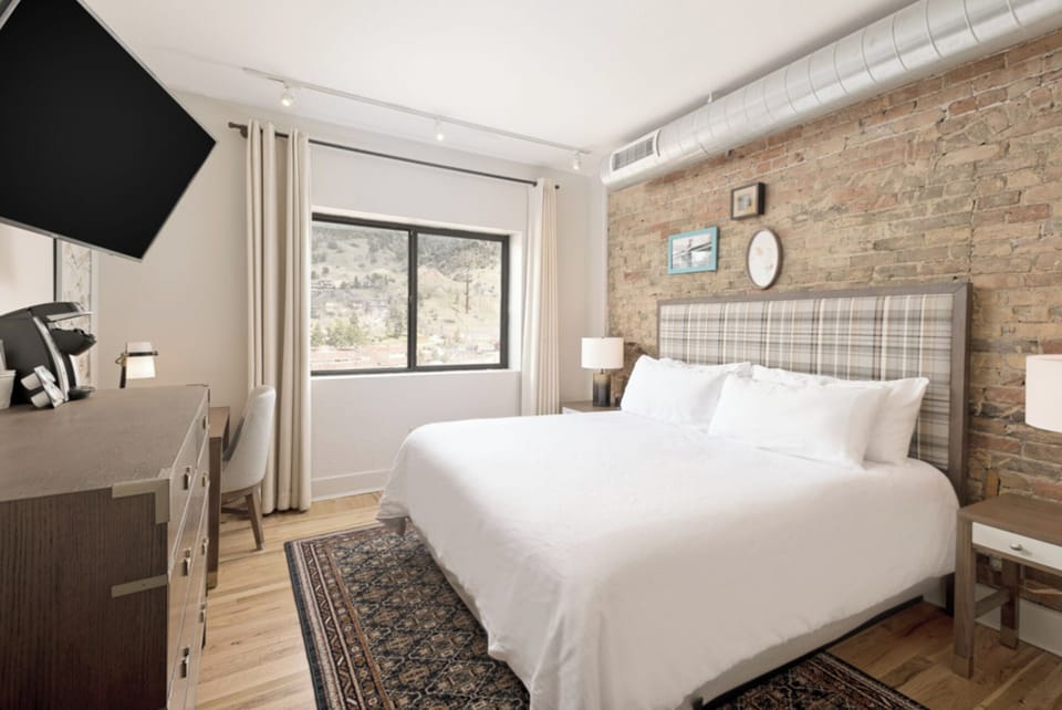 Wake up to mountain views beside a warm brick wall.