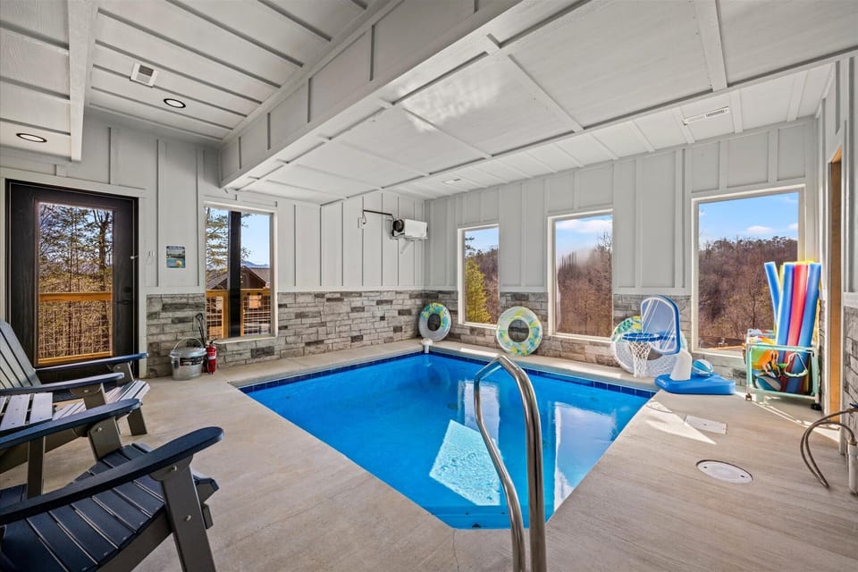 The dedicated indoor pool room offers year-round swimming with poolside seating and natural light.