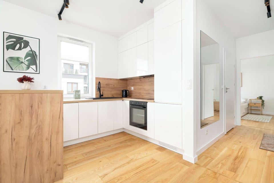 The sleek design of the kitchenette blending seamlessly with the living area.
