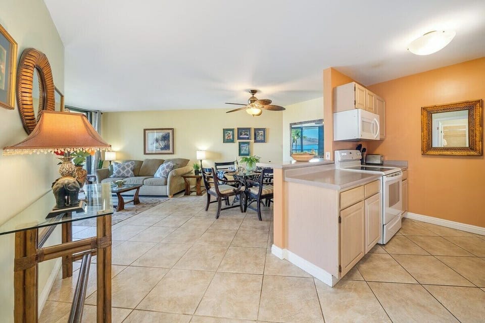 An open kitchen and dining area with bright cabinetry and a comfortable layout perfect for relaxed island living.