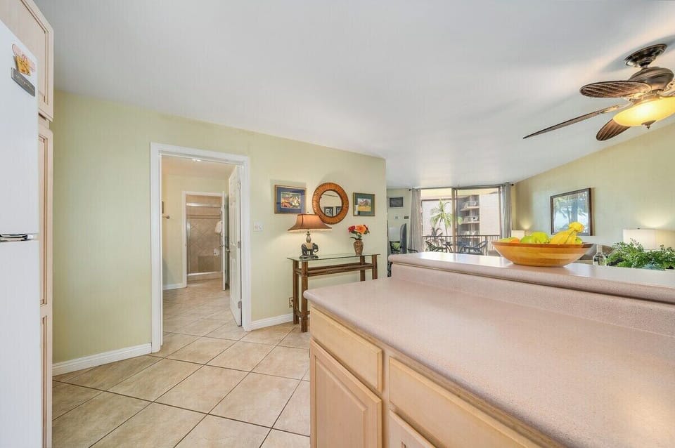 A wide, open living space with warm décor, comfortable seating, and a relaxing island atmosphere.