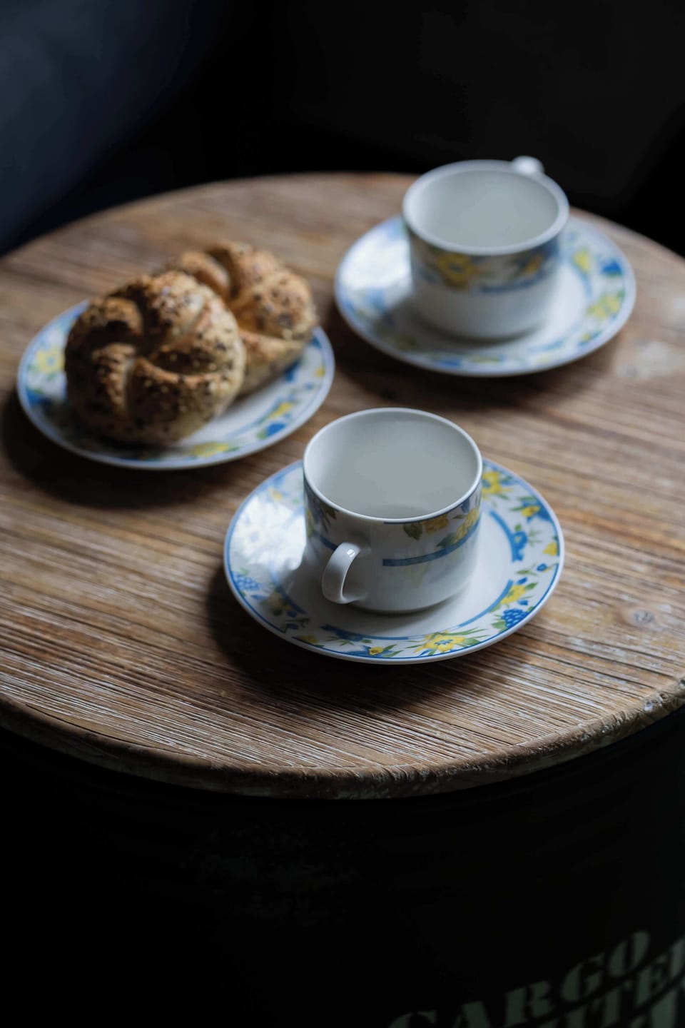 Tastefully styled coffee setting displayed on a round wooden table.