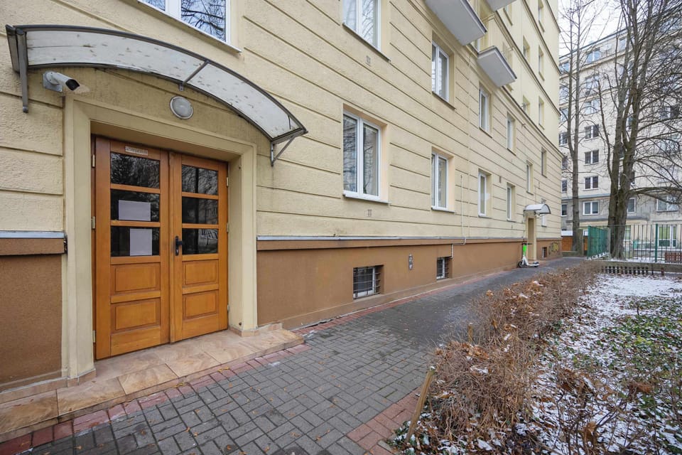 Quiet residential entrance showing the building façade and pathway.