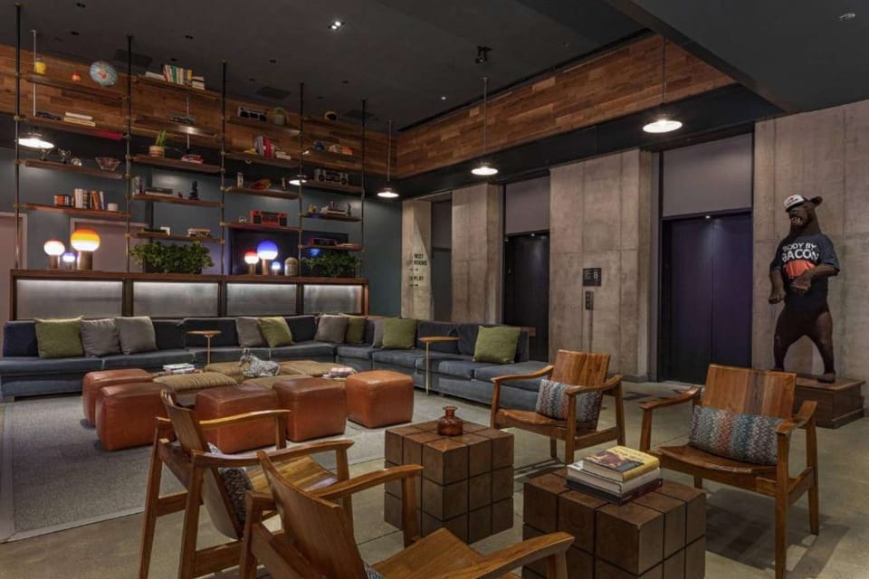 Spacious lounge with leather seating, wood shelves, art accents
