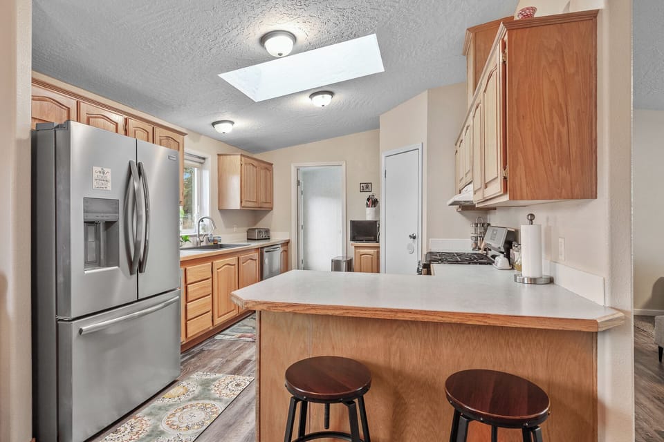 This functional kitchen space is designed for both efficiency and comfort, making it a delightful hub for culinary activities.