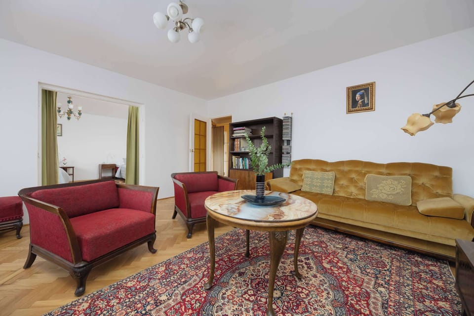 The living area features a coffee table and a flat-screen television.