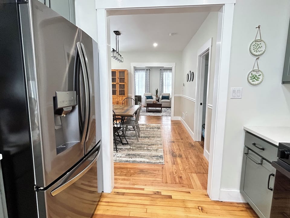 View from Kitchen through Dining to the Living Room, Bedroom to the right