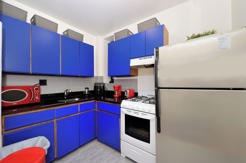 Your bright kitchen features bold blue cabinets, modern appliances, and everything needed for home-cooked meals during your stay.