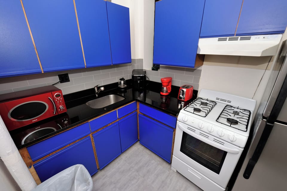 Your fully equipped kitchen features bold blue cabinets, modern appliances, and everything you need to prepare delicious meals during your stay.