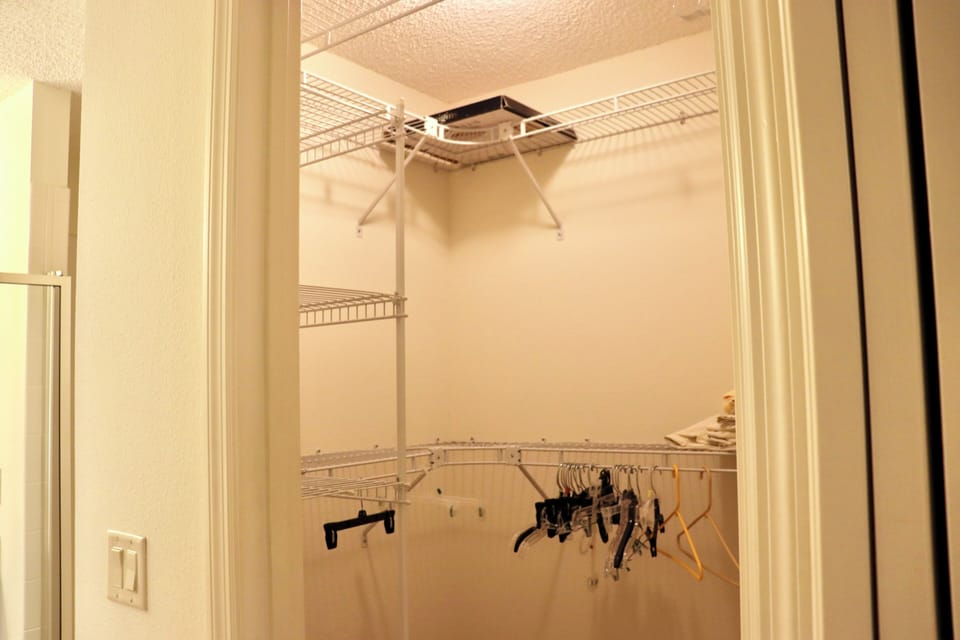 Your walk-in closet features organized wire shelving and hanging space to keep your belongings neatly arranged during your stay.