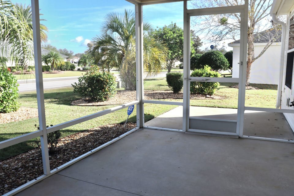 Step into your screened lanai where you can enjoy peaceful garden views and tropical breezes in complete comfort.