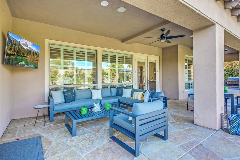 Spacious outdoor living with a comfortable lounge area, shaded patio, and beautiful desert landscaping—perfect for relaxing and enjoying the sunshine.