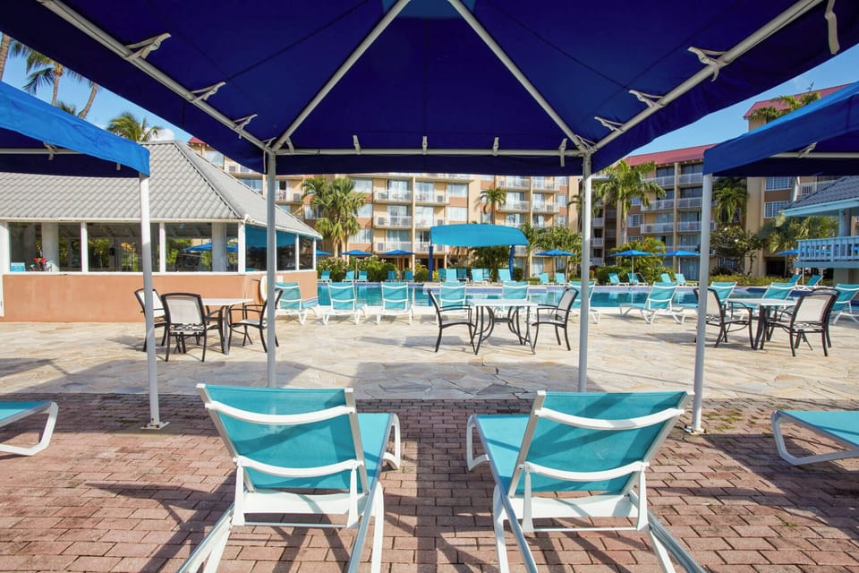 Stretch out in the shade while the pool sparkles nearby.