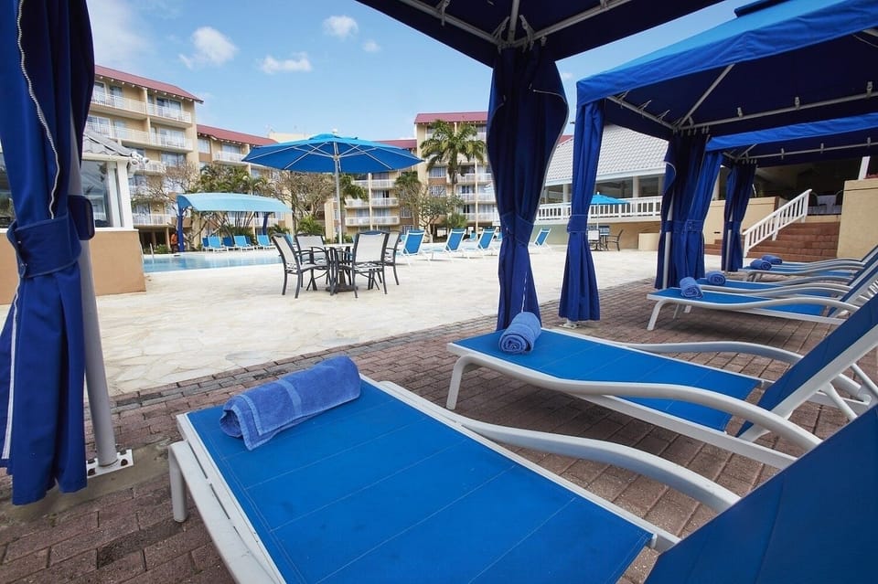Unwind in cushioned loungers with cool towels and shade.