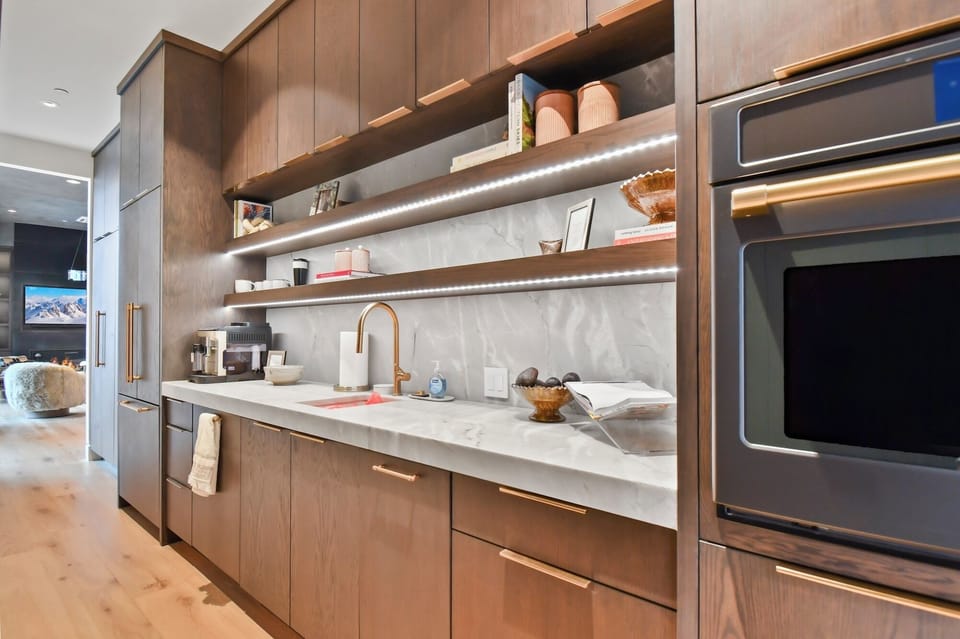 Create culinary masterpieces in your sleek kitchen with marble counters, warm lighting, and premium appliances.