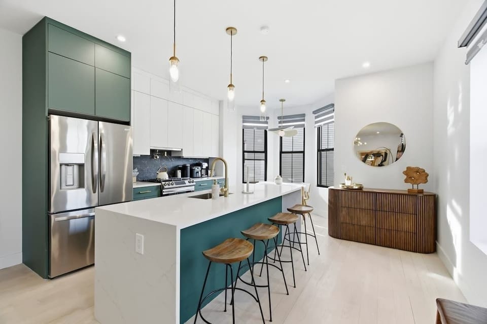 Fully equipped kitchen with a stylish bar and seating, offering a comfortable and practical space to enjoy meals and gather.
