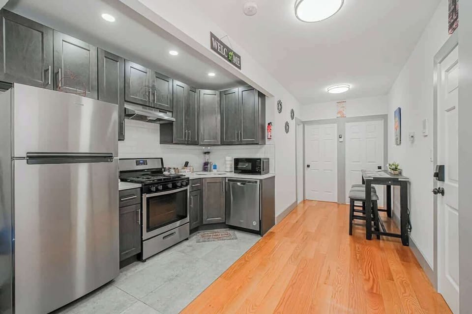 Spacious kitchen with stainless steel appliances and modern cabinetry, perfect for home-cooked meals.