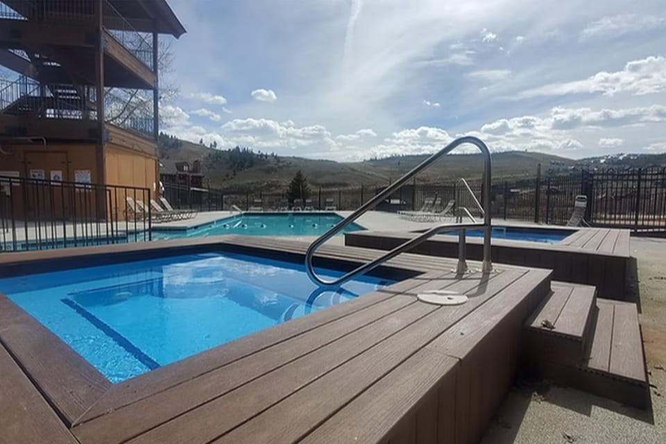 Resort hot tub and pool area with scenic mountain backdrop