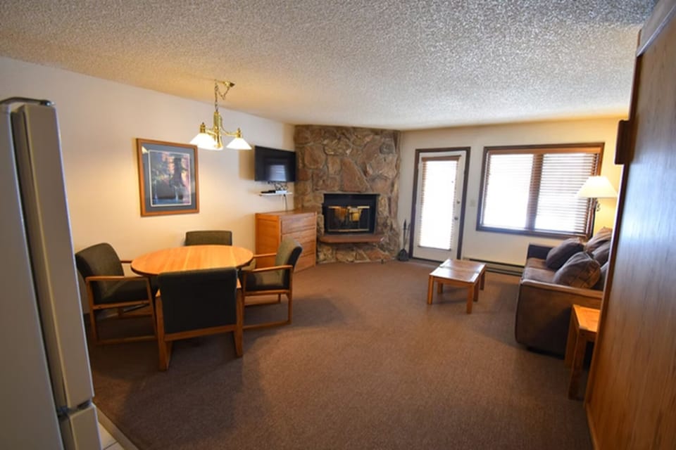 Spacious studio living area with fireplace and comfortable seating