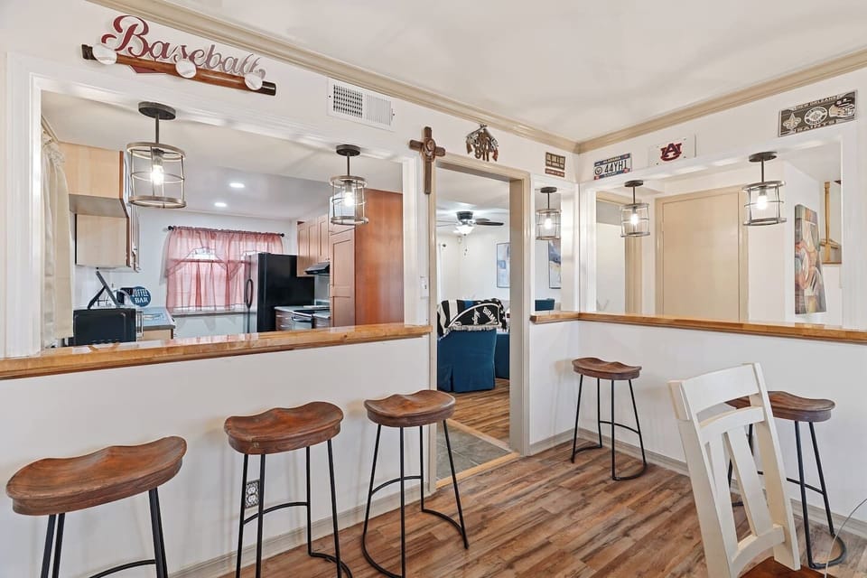 Adjacent sports bar area with pitchers—perfect for entertaining and game day gatherings.