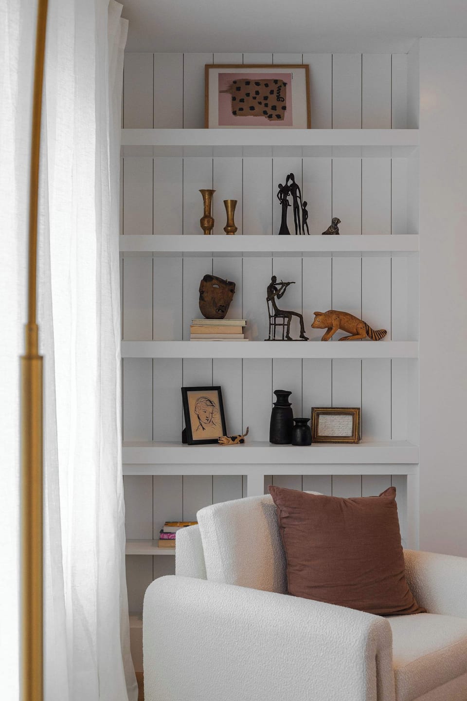 Thoughtfully styled built-in shelves add warmth and character to the space, featuring curated decor and cozy touches. A subtle detail that elevates the home’s design.