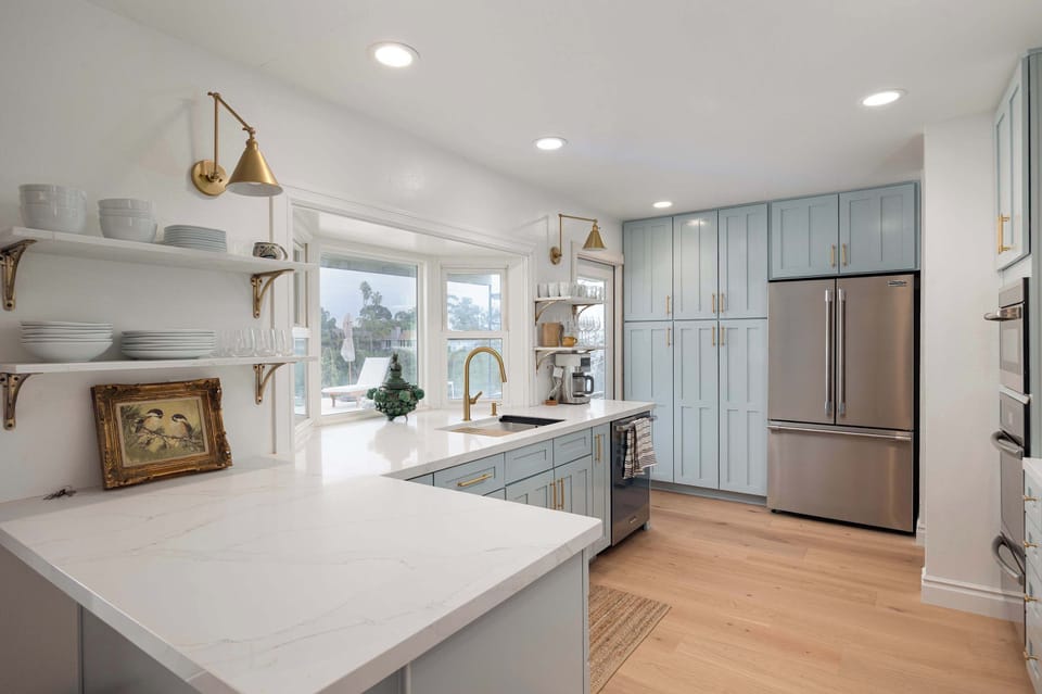Bright and beautifully styled, this kitchen features open shelving, modern finishes, and plenty of space to cook and gather. A perfect blend of charm and functionality.