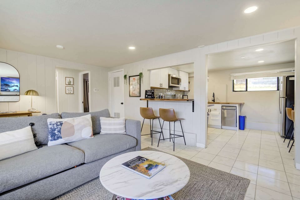 Open living area with comfortable seating and a clear sightline into the kitchen, making the space feel connected and easy to share.