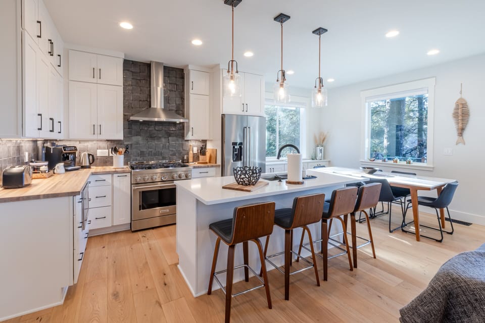 Thoughtfully designed kitchen with 6-burner gas range, espresso maker, and everything for gathering and cooking.