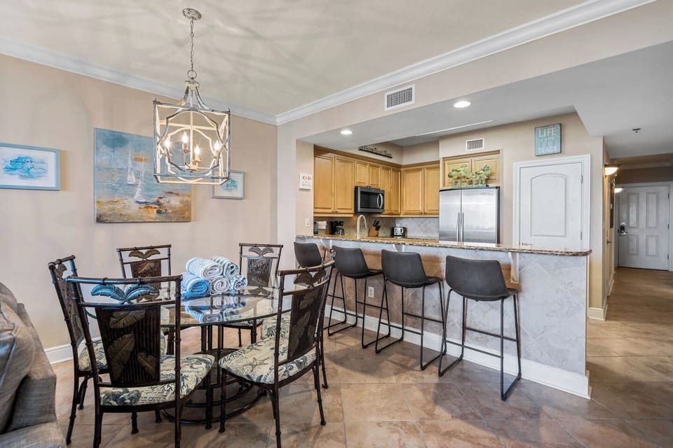 Dining table seats 5-6 people with 4 additional spots by the countertop