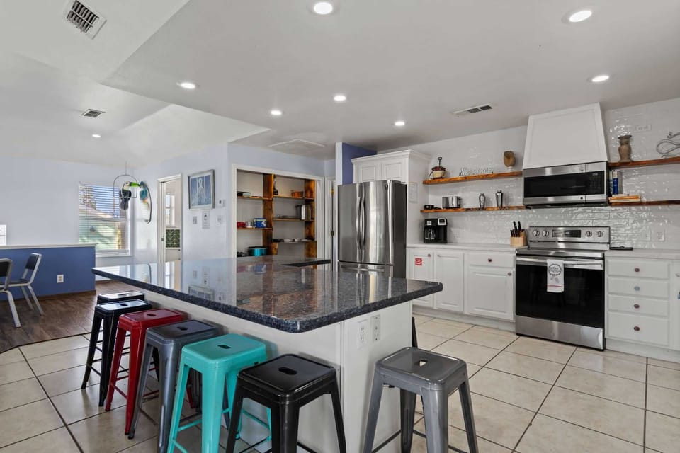 Stainless appliances and open shelving keep cooking easy