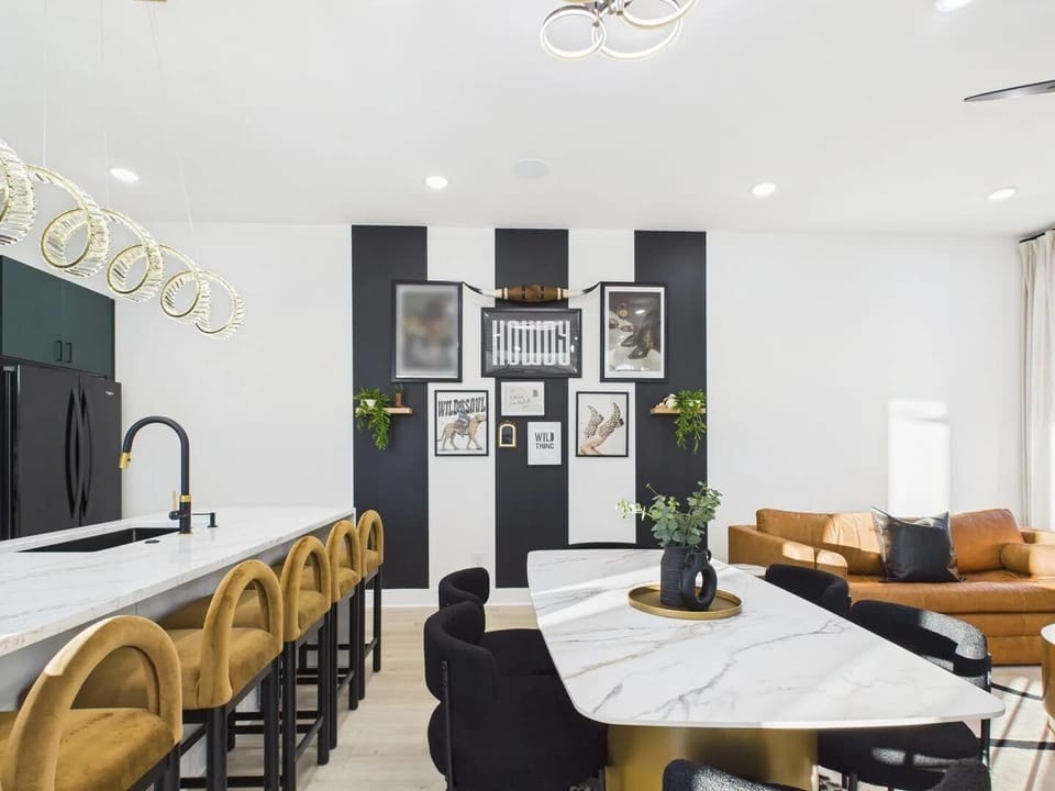 2nd Floor: Dining area featuring a marble and gold table paired with black chairs, offering seating for 6 guests.