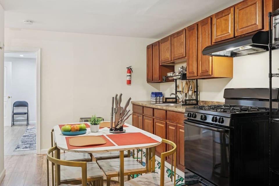 Spacious kitchen and dining area with full‑size appliances, cookware, and seating for comfortable long‑term living and daily meals.