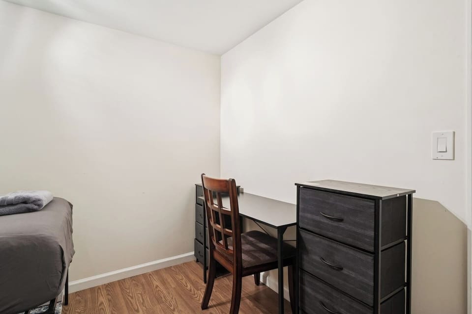 Bedroom with two comfortable twin beds and a dedicated workstation — ideal for travel nurses, remote workers, and long‑term stays.
