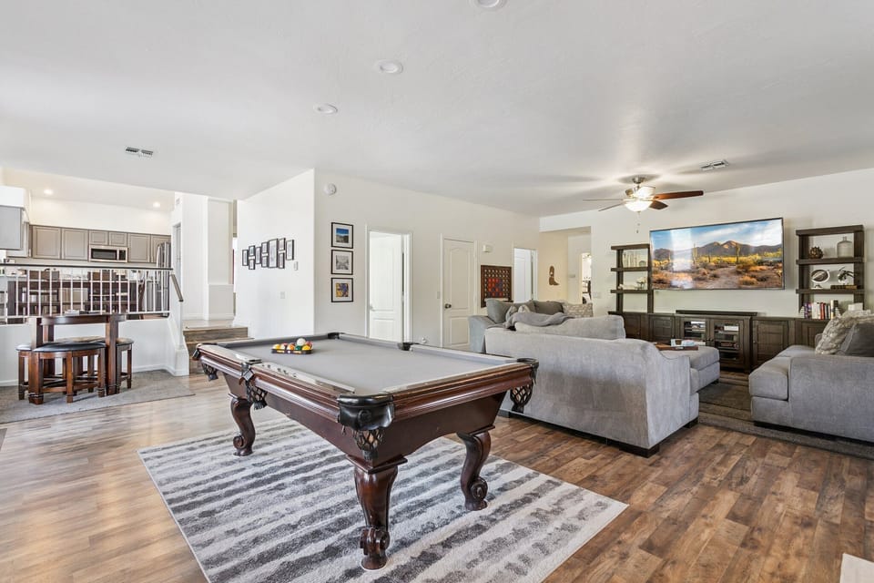 Your spacious open living area blends comfort with entertainment, featuring a full billiard table and cozy seating perfect for relaxing evenings.