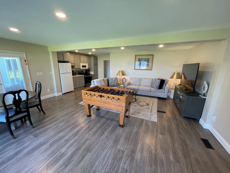 Living Room: couch, large 4K HD smart TV, foosball, ...