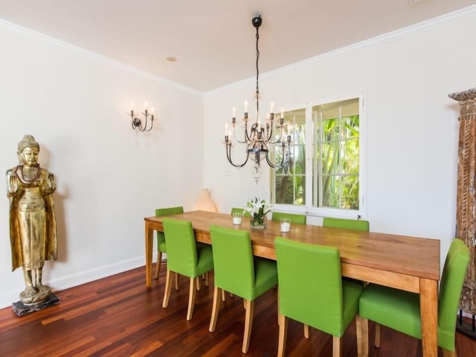 Gather around the dining table with seating for eight in a bright, elegant setting.