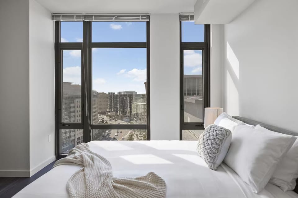 Drift off while city lights glow beyond tall windows.