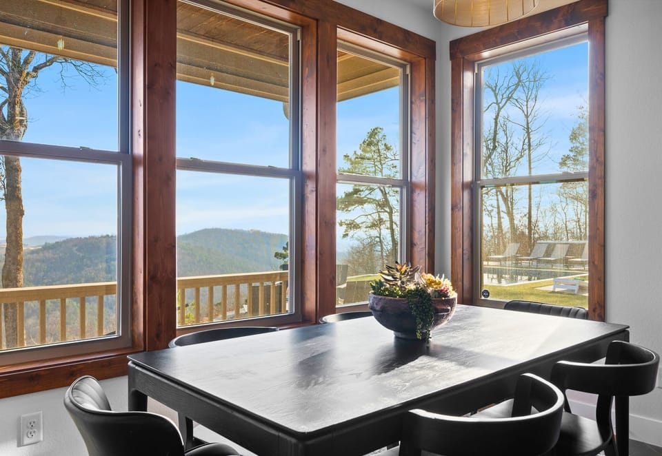 Start your morning with coffee at this table as sunlight fills the room and the hills roll out beyond the deck.