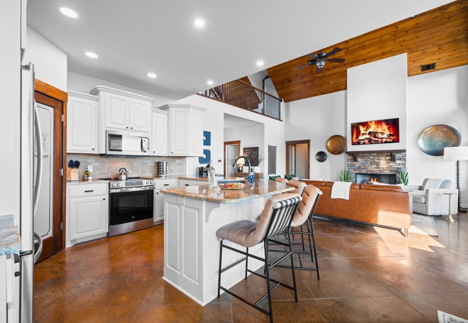 Whether you’re cooking, chatting, or just enjoying the fireplace view from the kitchen, everything feels connected and inviting.