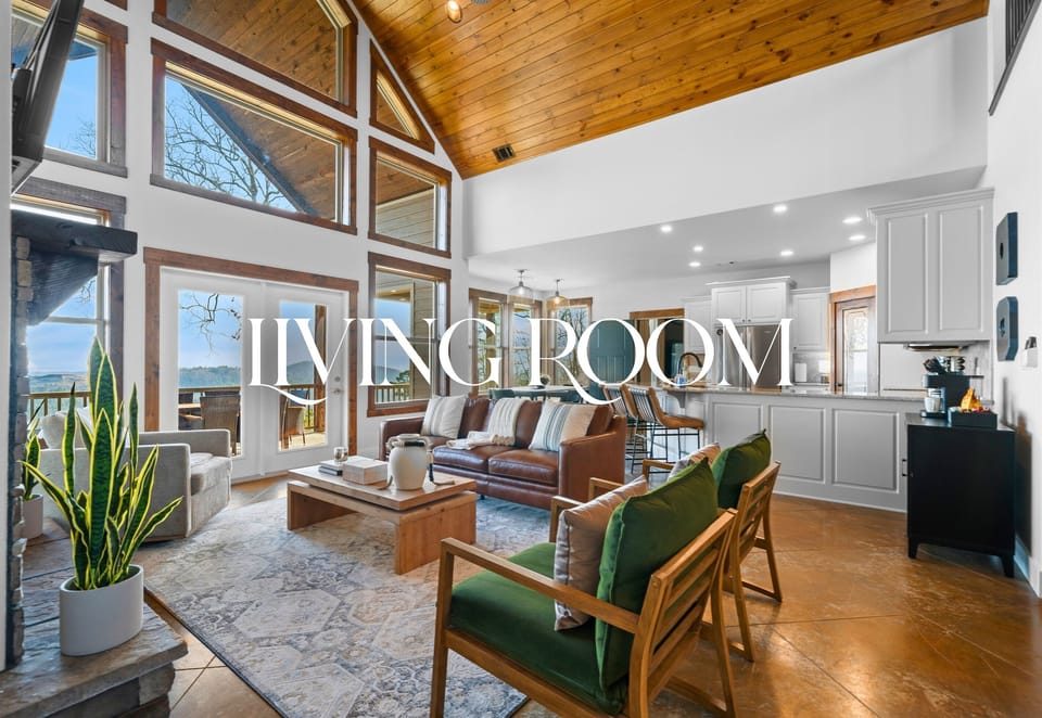 The open living room invites everyone to relax together, with cozy seating, warm wood ceilings, and natural light pouring in from every angle.