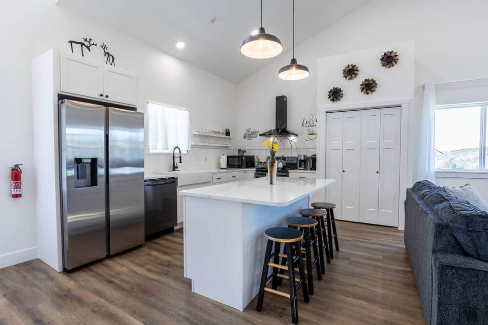 Open kitchen with large island and bar tools