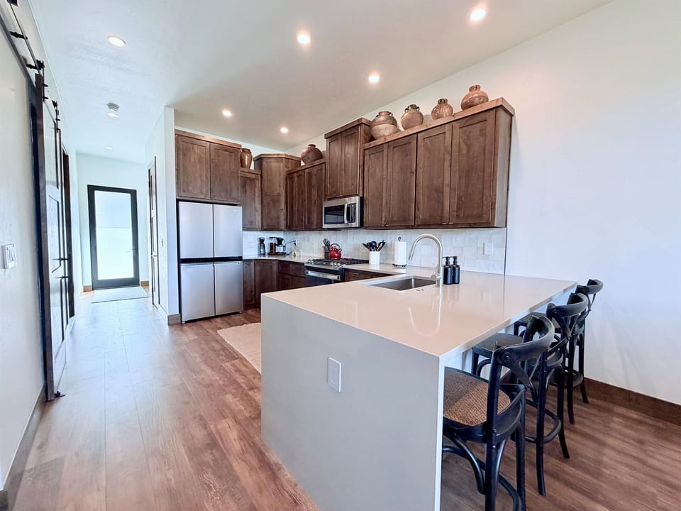 1) Large kitchen island with bar seating, perfect for casual meals, coffee, or entertaining.
