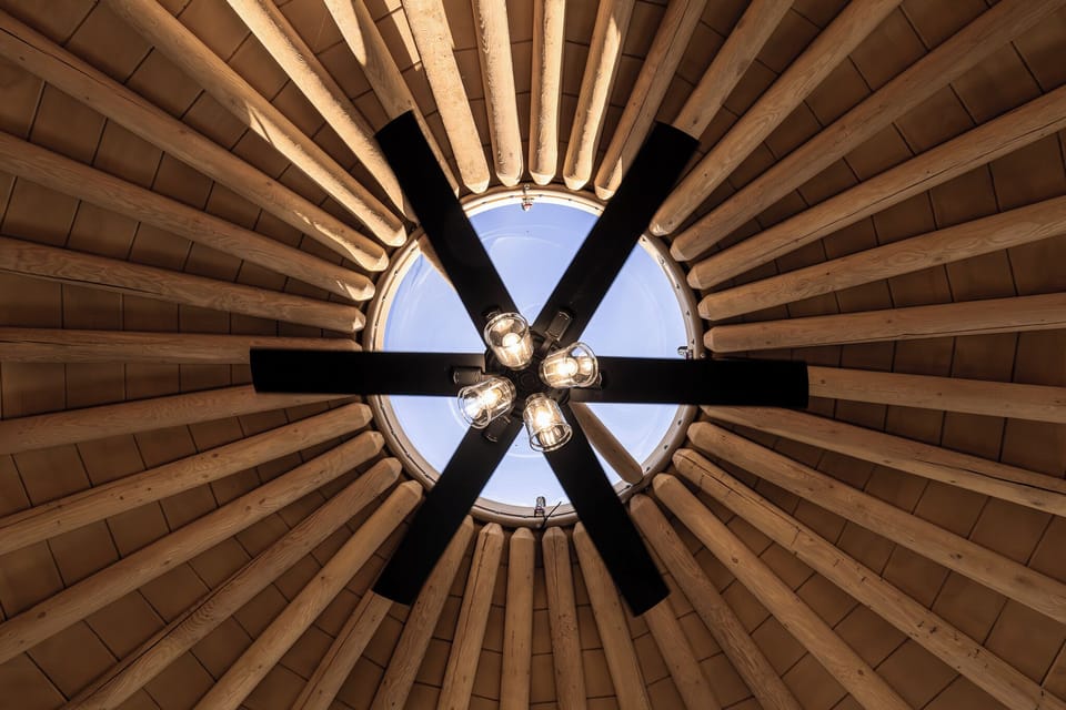Look straight up to the dome’s skylight and soaring timber ceiling, a signature feature that fills the space with natural light.